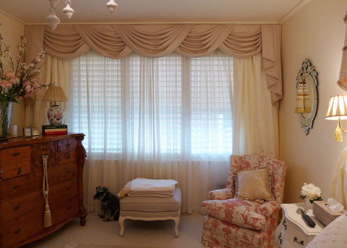 Window in French bedroom with sheer curtains