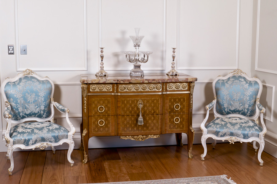 Blue salon chairs with ornate dresser