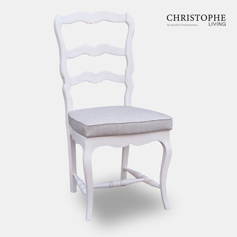 French country chair or farmhouse style dining chair painted white with ladder back carved design and light grey upholstered cushion seat