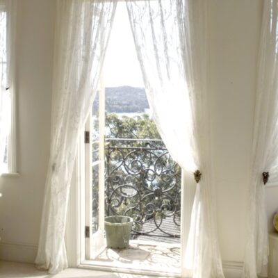 French Style Home Bedroom Window with White Curtains & Gold Pelmet
