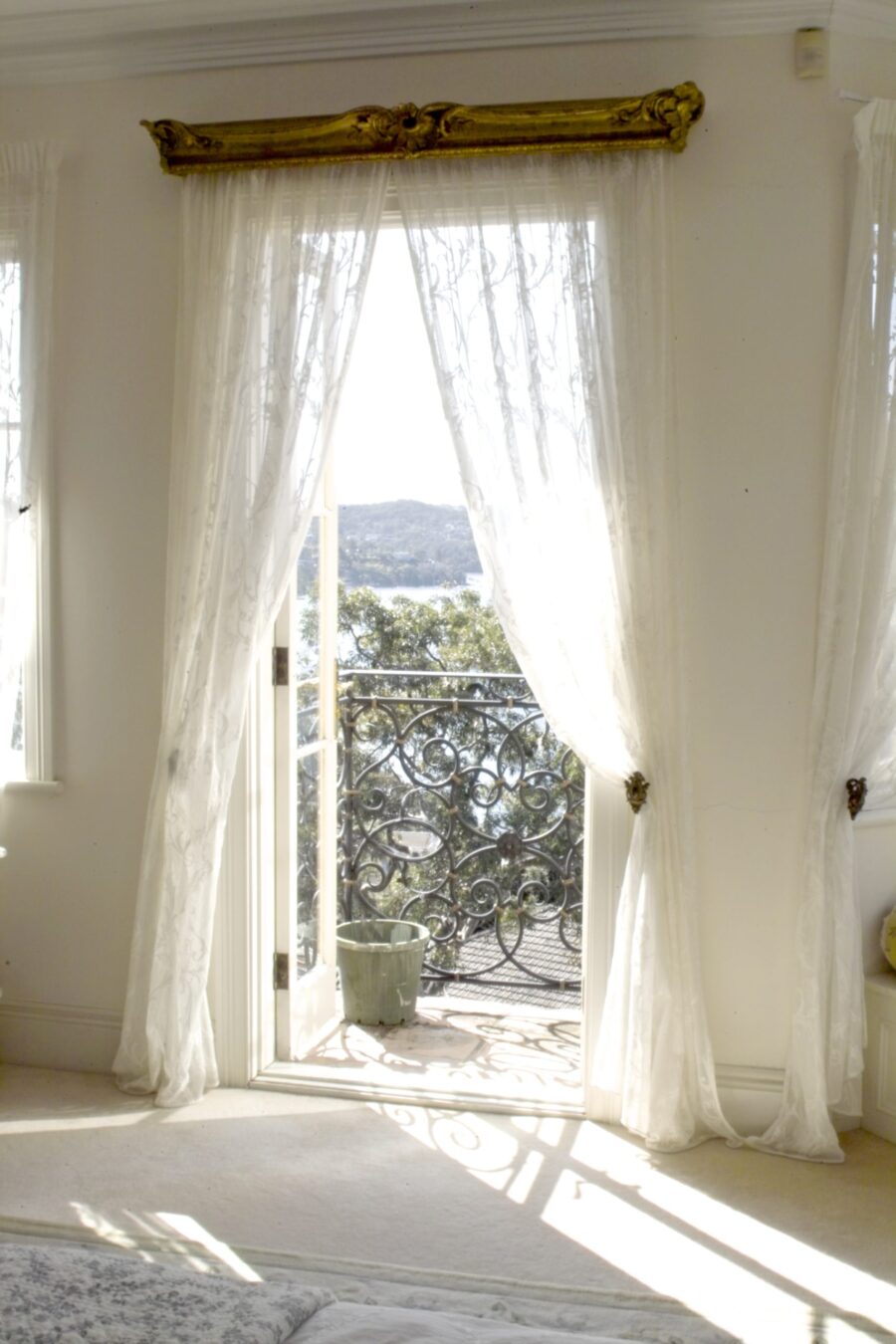 French Style Home Bedroom Window with White Curtains & Gold Pelmet
