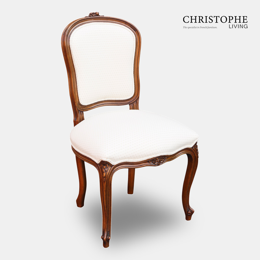 Dining chair in French style in timber with carved legs upholstered in cream fabric with shield back design.