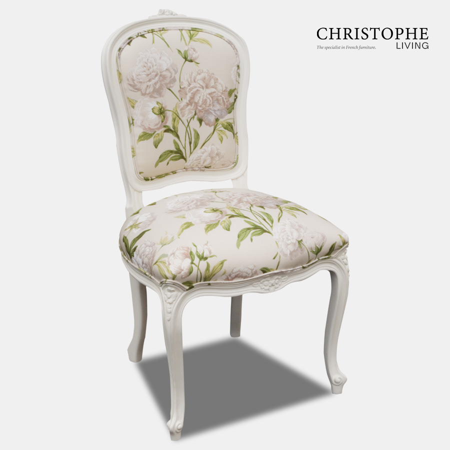 White French provincial dining chair with cream and green floral fabric and shield back shaped seat.