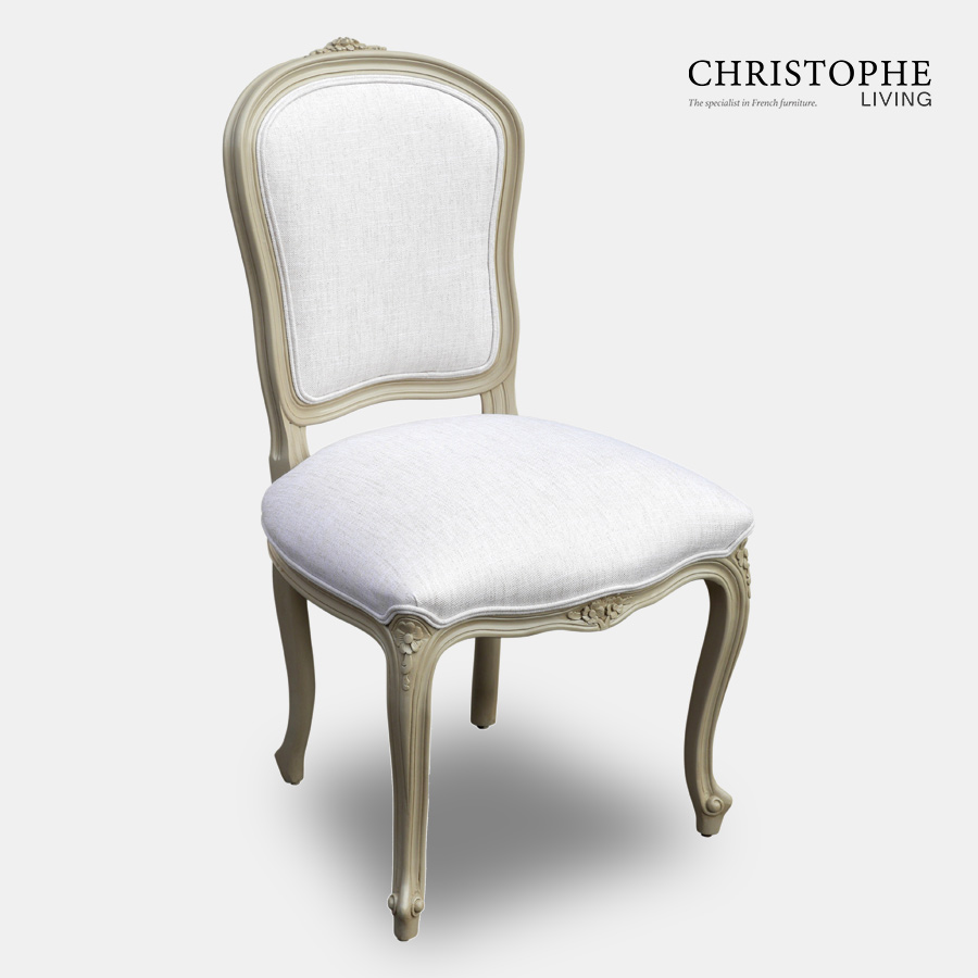 Classic looking shield back dining chair with a painted finish and upholstered in white linen