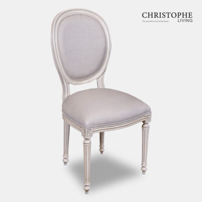 White oval shaped Hamptons style French dining chair in antique white upholstered with grey embroidered linen