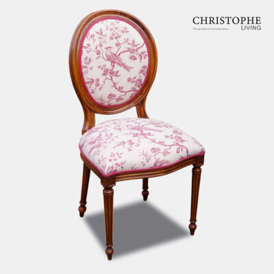 Louis oval back dining chair in timber with red and cream bird toile linen and a double row of red contrast piping.