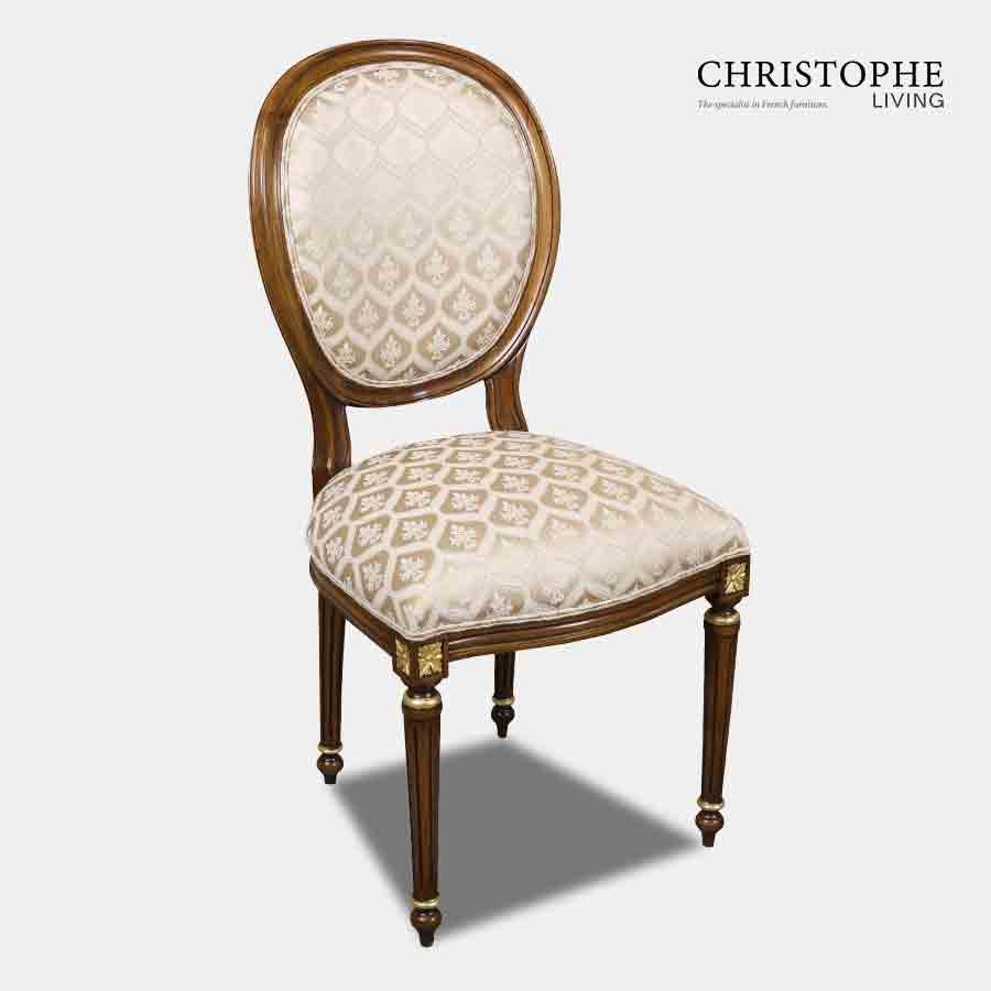 Classic looking chair in French Louis style with cream damask and gold on chair legs carving