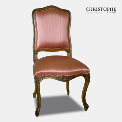 Classic looking French Louis XV dining chair in timber with carving and floral motif and pink satin fabric upholstered seat and back
