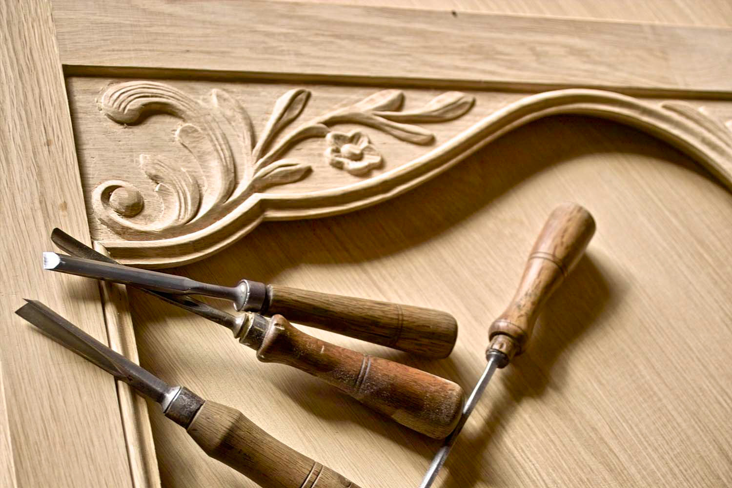 1 Carving tools and timber furniture being made with decorative carving motifs