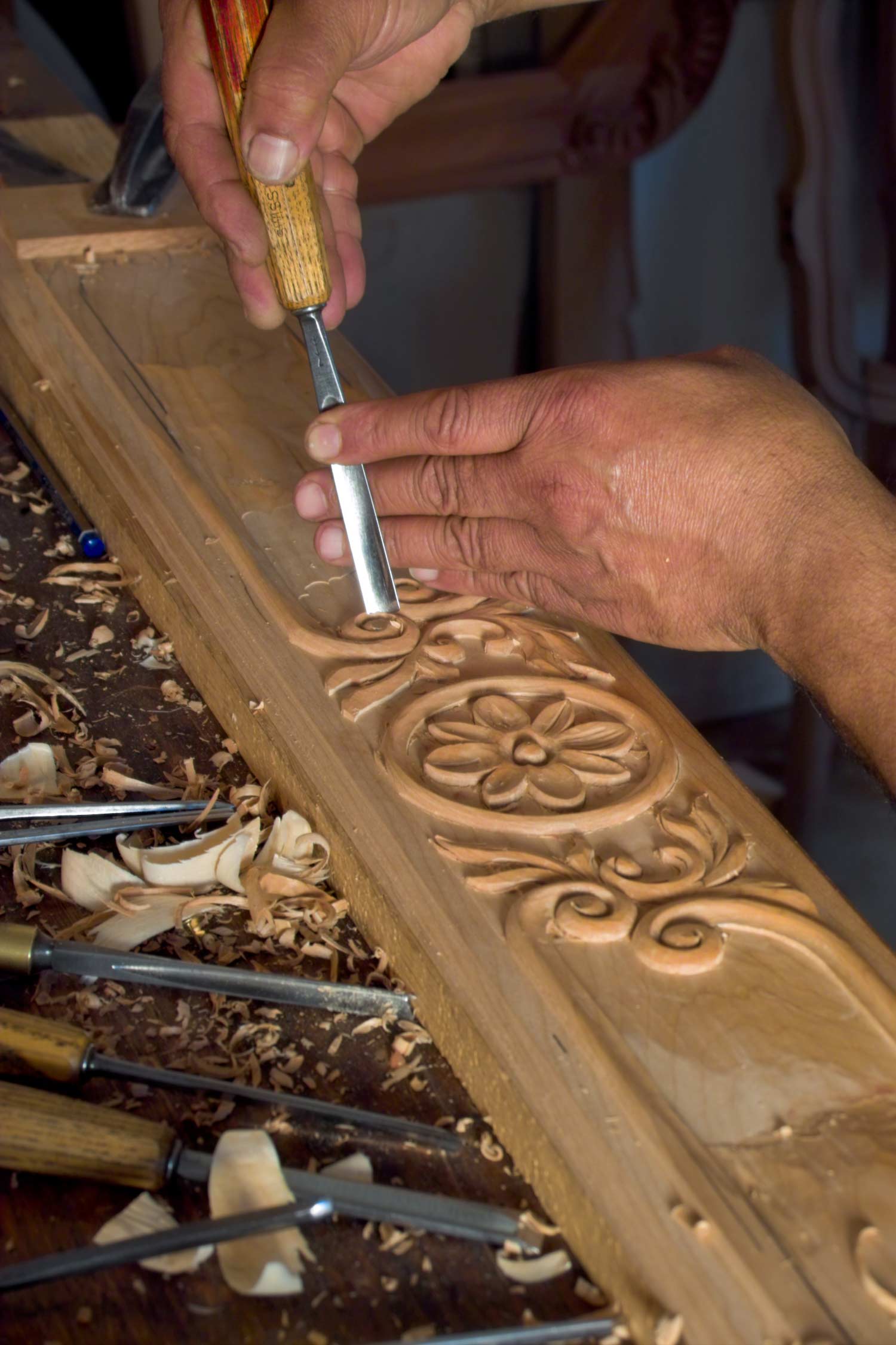 2 Craftsman working on a timber panel carving floral ornate details by hand