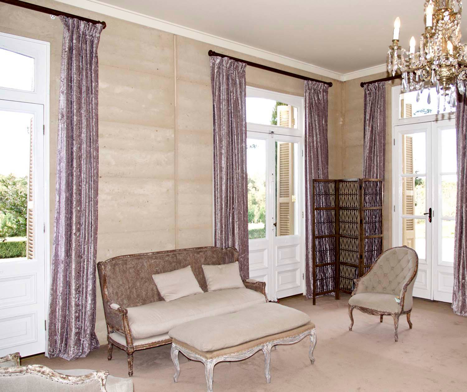 3 French lounge room with sofa bed, chandelier and armchair with large curtains