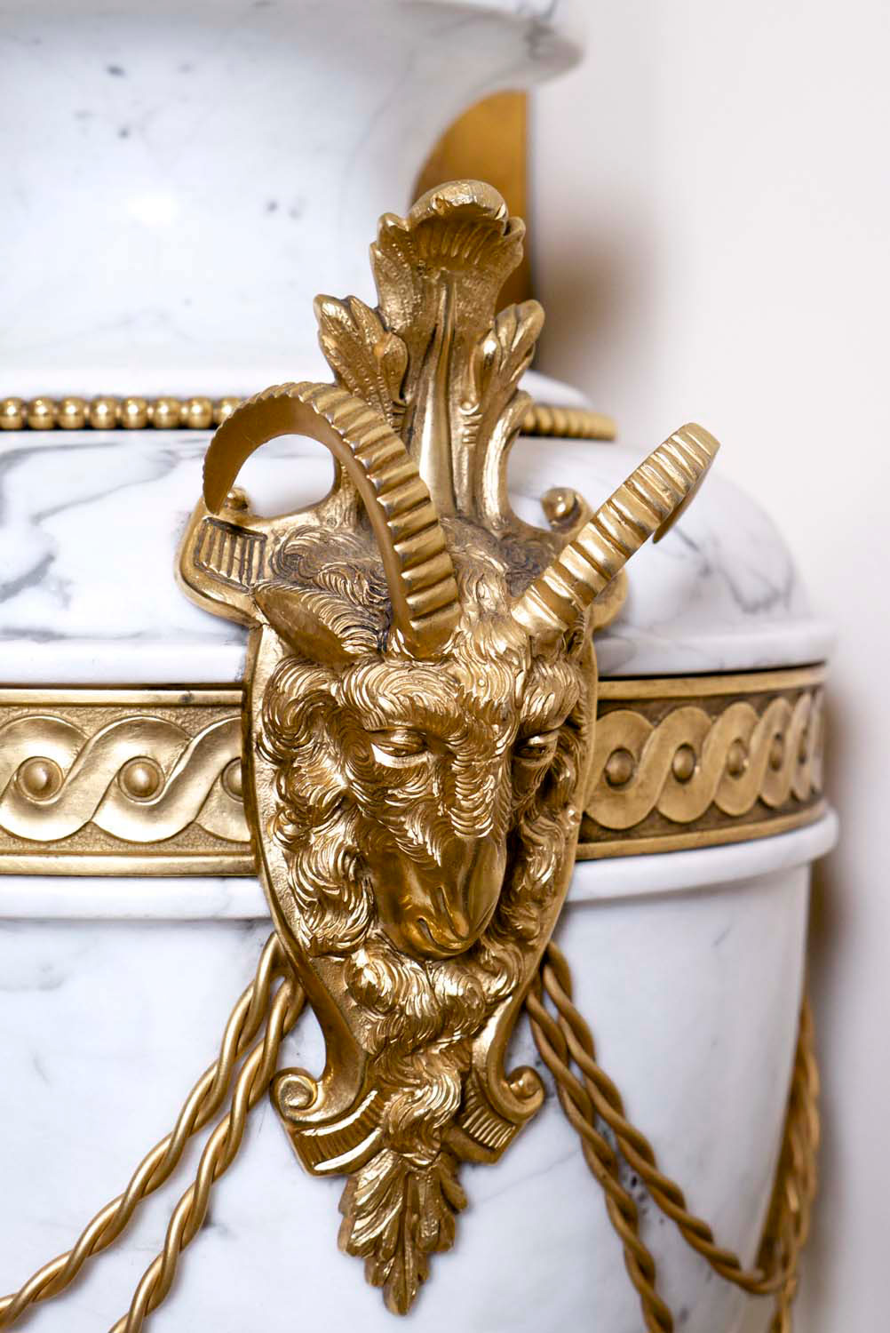 4 Gilding detail on french décor urn with deocrative motif positoned in hall way