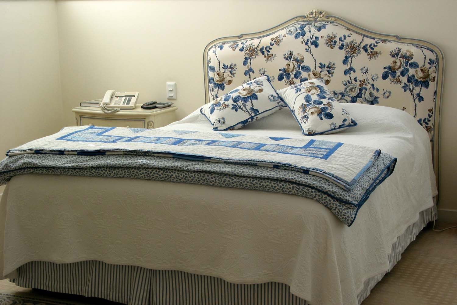 6 French bed with white painted bedhead and blue floral patterns