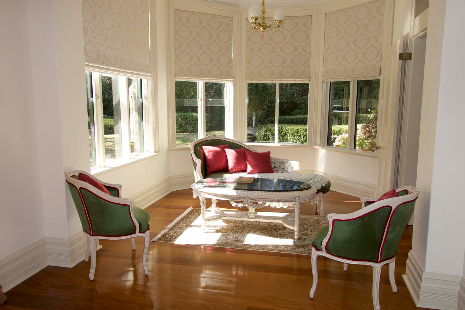 8 Lounge room sitting area with sofas and armchairs in french style in curtain blinds