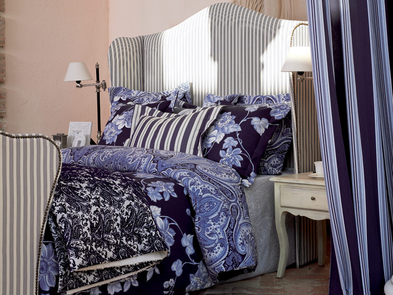 French bed with blue patterned bed linen