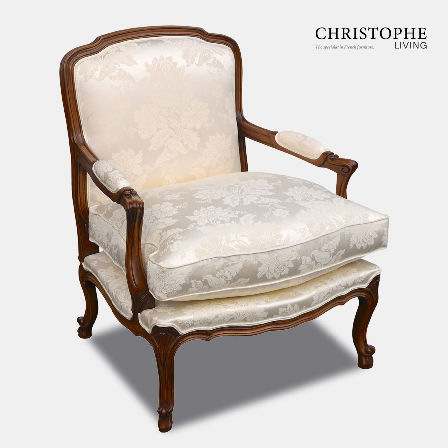 Quality carved walnut timber French armchair with loose cushion, cream damask fabric and curved legs for the loungeroom.
