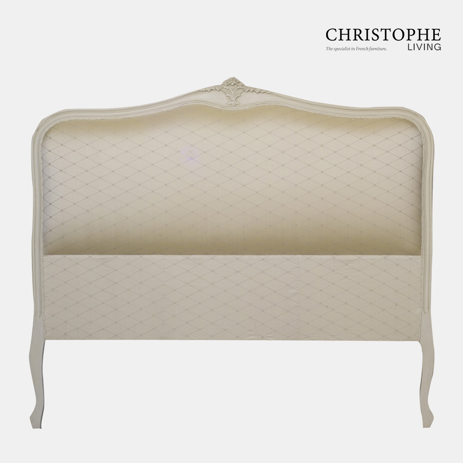 French style bedhead in antique white with carving at top and curved legs in diamond fabric