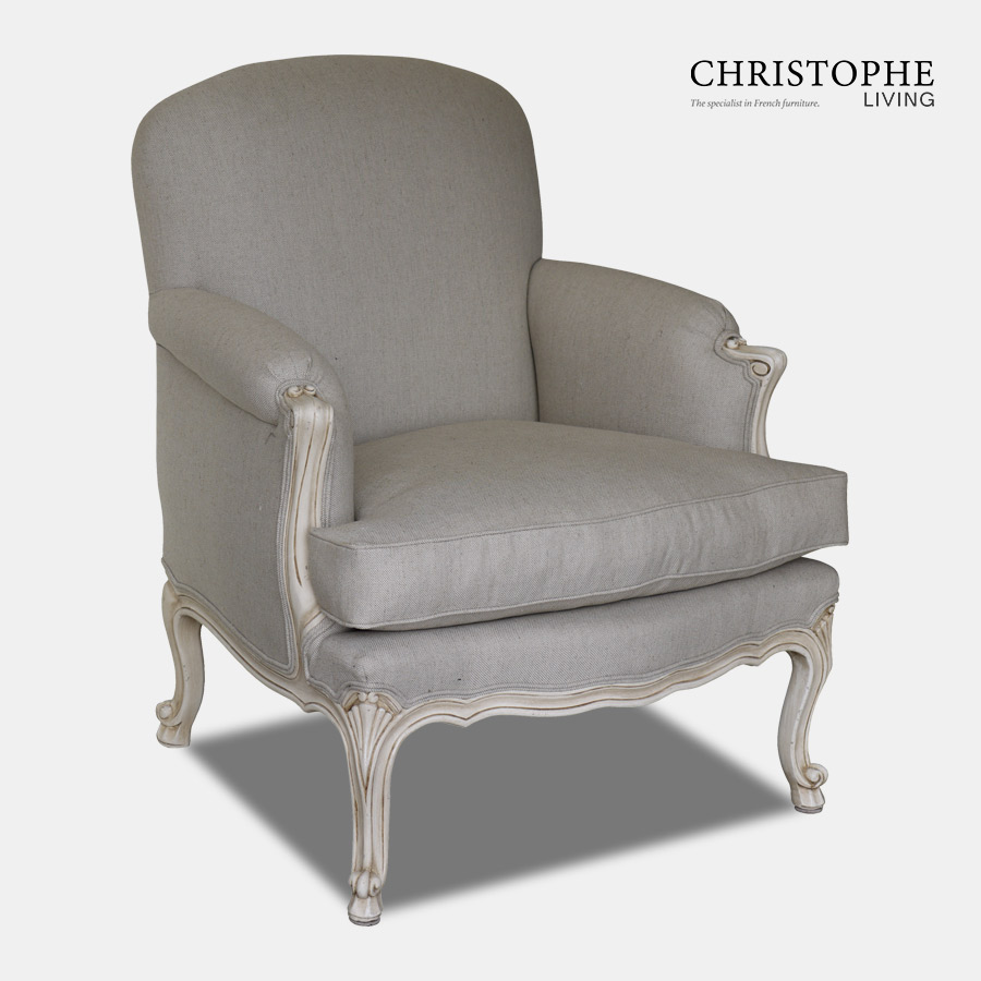 Linen fabric upholstered and loose cushion on armchair in French Louis antique style with cream painted finish.