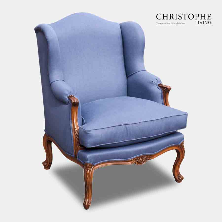 Wing chair in French style fully upholstered in a medium blue fabric with timber walnut frame.