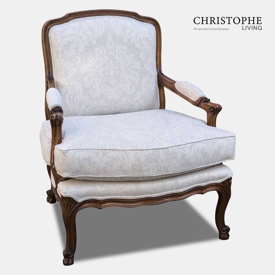 Timber armchair in the French provincial style with a hand applied timber finish. Upholstered in a light linen damask fabric with upholstered arm rests.