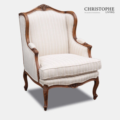 Beautiful French antique style loungeroom armchair with carved motif and timber walnut finish in cream fabric.