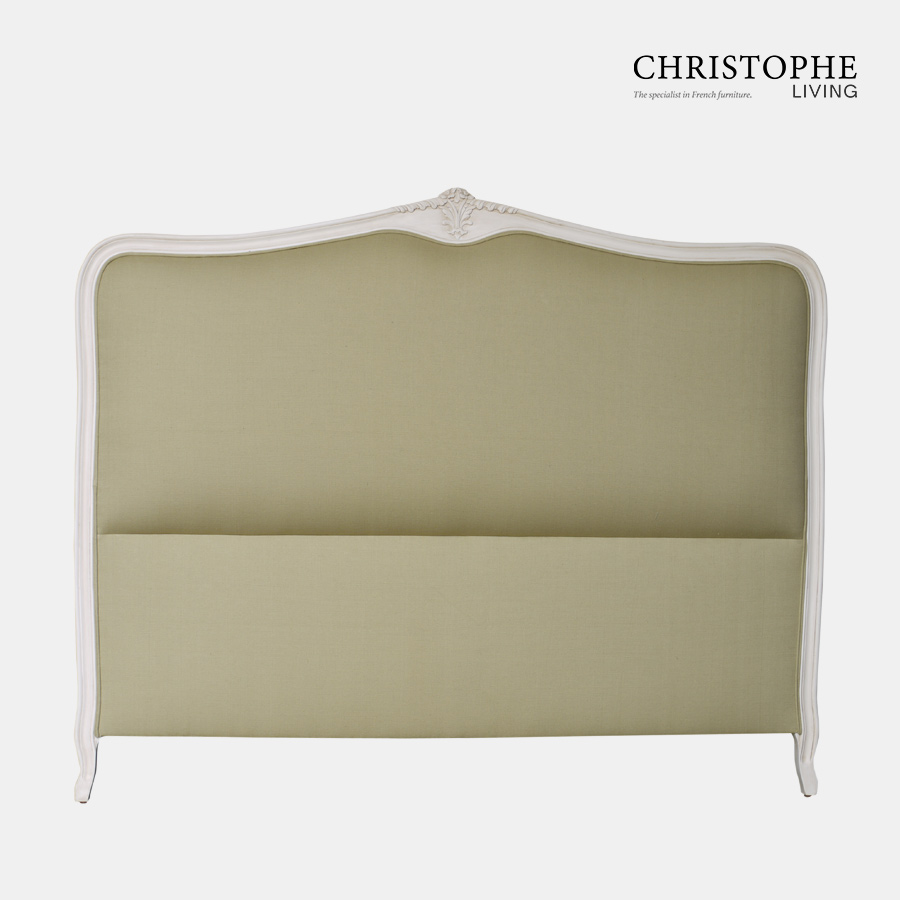 White painted French style bedhead upholstered with green linen fabric with cabriole legs and carving top