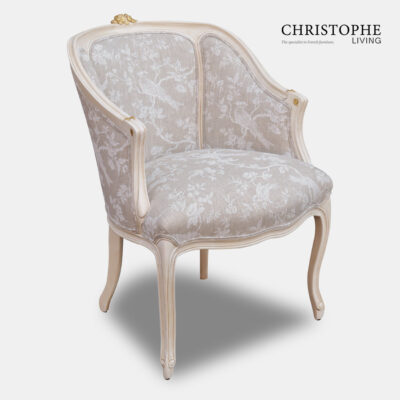 French style fully upholstered chair with beige and white linen French fabric in Louis XV furniture style with carved motif at top.