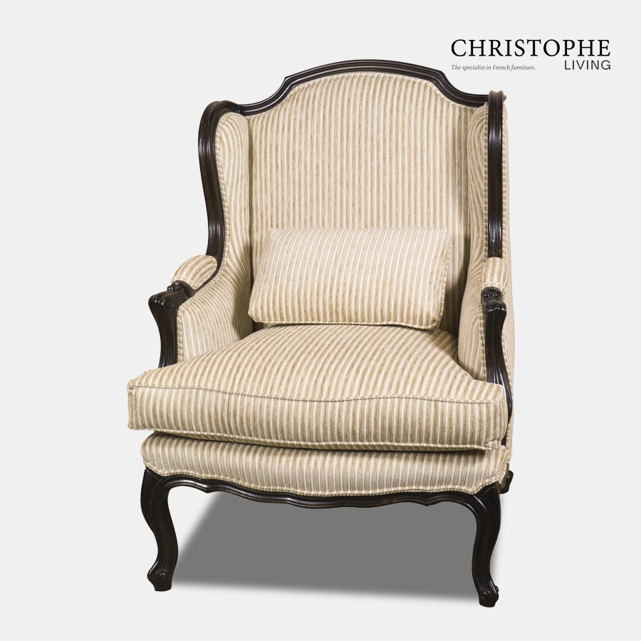 Classic antique style armchair painted in black with golden stripe fabric and matching pillow with upholstered armrests.