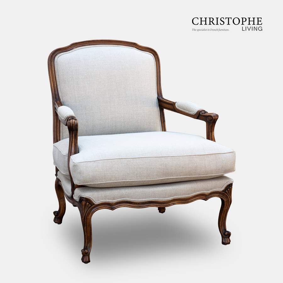 French country armchair upholstered in light linen fabric with a timber finish and hand done carving in Italy.