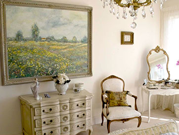 french bedroom furniture with art, chair and chandelier